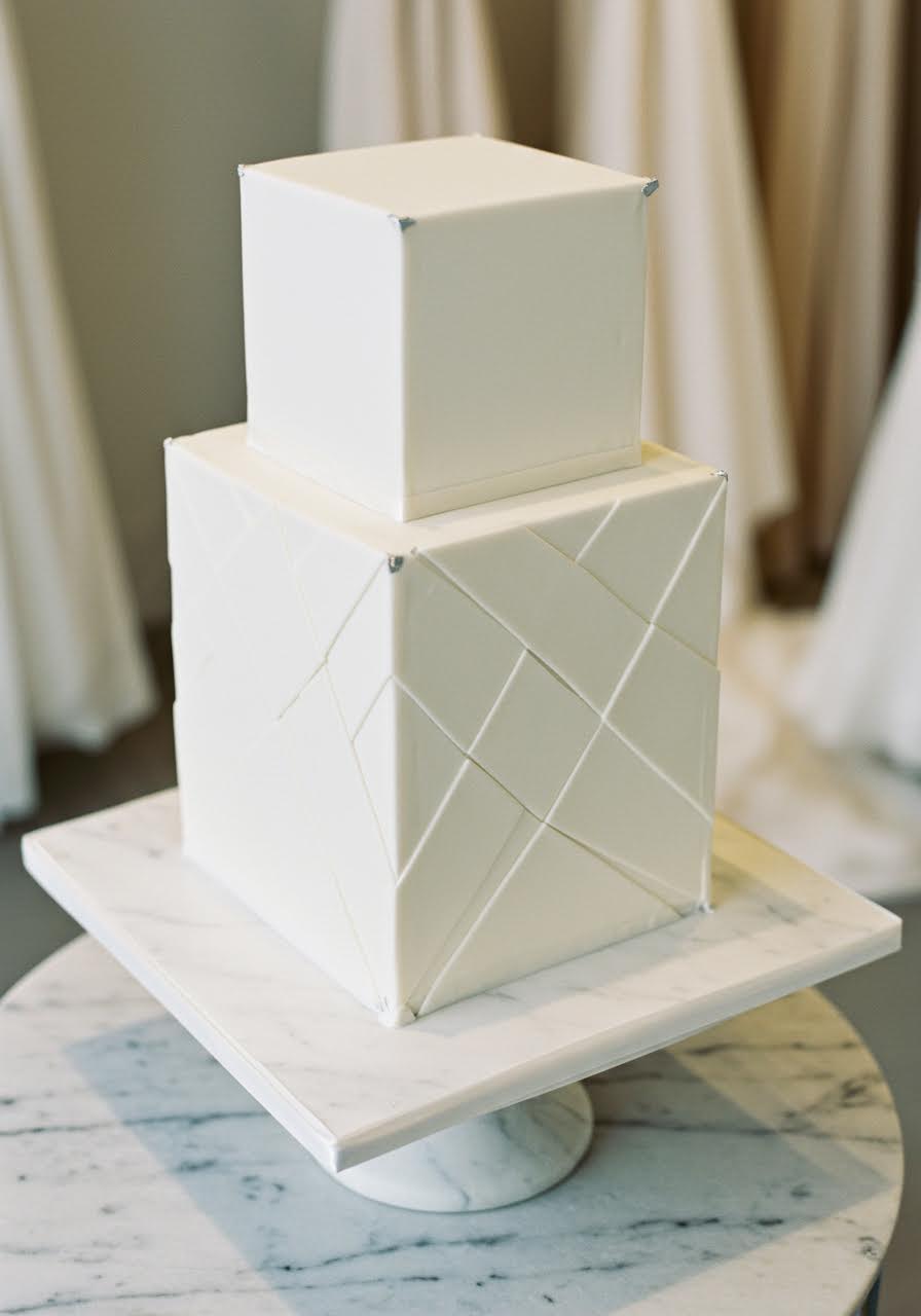 Overhead perspective of minimalist square wedding cake highlighting clean architectural lines